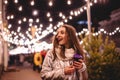 Cheerful happy young woman walking in city street