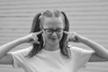 Headstrong pretty kid, teen age girl, being in great mood and showing her smile and long hair tails. Black and white image