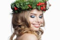 Cheerful healthy young woman with party makeup, long blonde curly hairdo and Christmas decor isolated on white background. Royalty Free Stock Photo