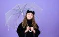 Cheerful hipster child in positive mood. autumn fashion. happy little girl with transparent umbrella. rain protection