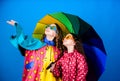 Cheerful hipster children, sisterhood. rain protection. Rainbow. autumn fashion. happy small girls with colorful