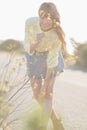 Cheerful hipster girl smelling flowers