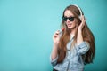 Cheerful Hipster woman with headphones and candy Royalty Free Stock Photo