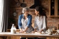 Cheerful Hispanic older 60s mom and grown daughter