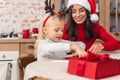 Cheerful housewife sitting with her cute daughter