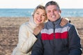 Cheerful husband and wife spend time together happily at sea beach Royalty Free Stock Photo