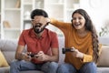 Cheerful Indian Couple Having Fun At Home, Playing Video Games Together Royalty Free Stock Photo