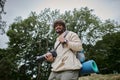 cheerful indian man holding digital camera