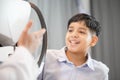 Cheerful Indian - Thai boy doing eye test checking examination with autorefractor in optical shop Royalty Free Stock Photo