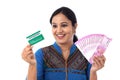 Cheerful Indian woman holding Indian rupee and credit cards