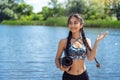 Cheerful Indian yogi woman with fitness mat against the river Royalty Free Stock Photo
