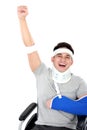 Cheerful injured young man raise his hand