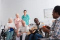 Cheerful interracial senior people with yarn