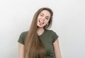 Cheerful ironic girl with long hair smiles at the camera