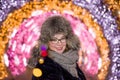 Portrait of cheerful joyful smiling girl in a winter fur cap against the background of night illumination in the winter in Moscow