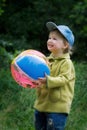 The cheerful kid with a ball