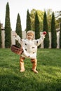 Cheerful kid with basket play in the garden Royalty Free Stock Photo