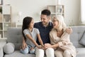 Cheerful kid girl and young dad visiting happy grandmother Royalty Free Stock Photo