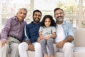 Cheerful kid and men of four family generations sitting close Royalty Free Stock Photo