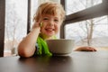 Cheerful kid sitting with plate Royalty Free Stock Photo