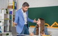 cheerful kid with teacher in classroom use laptop Royalty Free Stock Photo