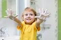 Kid washing hands and showing soapy palms Royalty Free Stock Photo