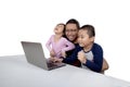 Cheerful kids and dad using laptop Royalty Free Stock Photo