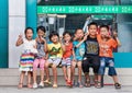 Cheerful kids in front of a pharmacy shop, Ruili, China