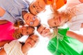 Cheerful kids standing closely in a circle touching their heads Royalty Free Stock Photo