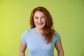 Cheerful kind happy redhead middle-aged mother look caring delighted smiling broadly gaze admiration joy stand blue t