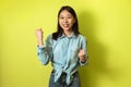 Cheerful Korean Female Gesturing Yes Standing Over Yellow Background