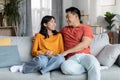 Cheerful korean lovers enjoying time together at home