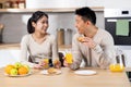 Cheerful korean lovers having snack together at home