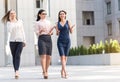 Cheerful ladies telling and going outdoor