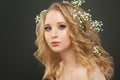 Cheerful lady with blonde curly hair and white flowers, beautiful face closeup Royalty Free Stock Photo