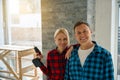 Cheerful lady and man standing near each other in room Royalty Free Stock Photo