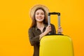 Cheerful Lady Tourist Posing With Suitcase Wearing Hat, Yellow Background Royalty Free Stock Photo