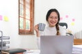 Cheerful lady working on laptop in home and use a computer laptop and thinking idea for her business Royalty Free Stock Photo