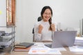 Cheerful lady working on laptop in home and use a computer laptop and thinking idea for her business Royalty Free Stock Photo