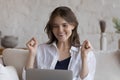 Cheerful laptop user looking at display, making winner yes hands Royalty Free Stock Photo