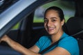 Cheerful latin woman while driving her car Royalty Free Stock Photo