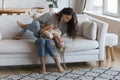 Cheerful Latina woman play with cute daughter at home Royalty Free Stock Photo