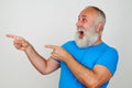 Cheerful laughing aged man looking and pointing to his right Royalty Free Stock Photo