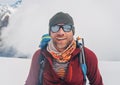 Cheerful laughing climber in sunglasses portrait with backpack ascending Mera peak high slopes at 6000m enjoying beautiful sunny Royalty Free Stock Photo