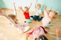 Happy kids holding hands up while playing together Royalty Free Stock Photo