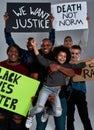 Cheerful little african american boy with young people