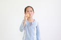 Cheerful little asian child girl hold and eating Custard Cake isolated on white background