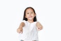 Cheerful little Asian girl child pointing at you and looking camera isolated over white background. Kid point to front Royalty Free Stock Photo