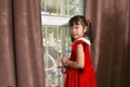 A cheerful little Asian girl wearing a Santa Claus costume Royalty Free Stock Photo