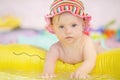 Cheerful little baby girl with Downs Syndrome playing in the pool Royalty Free Stock Photo